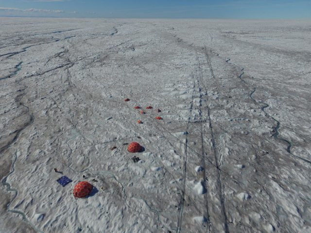 Microbes fuelled by wind blown mineral dust melt the Greenland ice sheet
