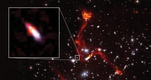 Cosmic lens reveals faint radio galaxy